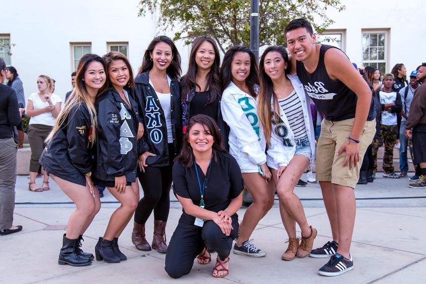 Fraternity and sorority members posing on the Paseo.